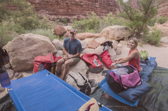 Man and woman on cots in Grand Canyon