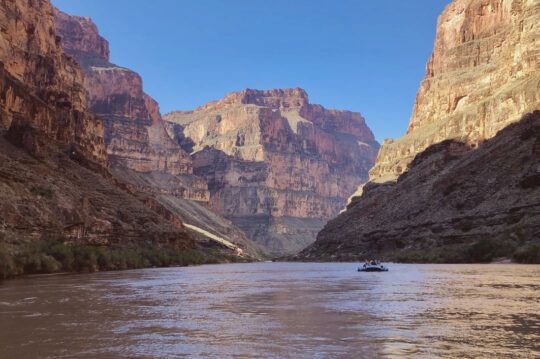 Scenic image of a small boat in the Grand Canyon