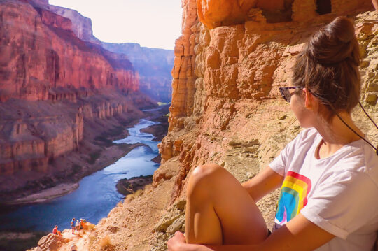 Woman looking over the Nankoweap Granaries in Grand Canyon.